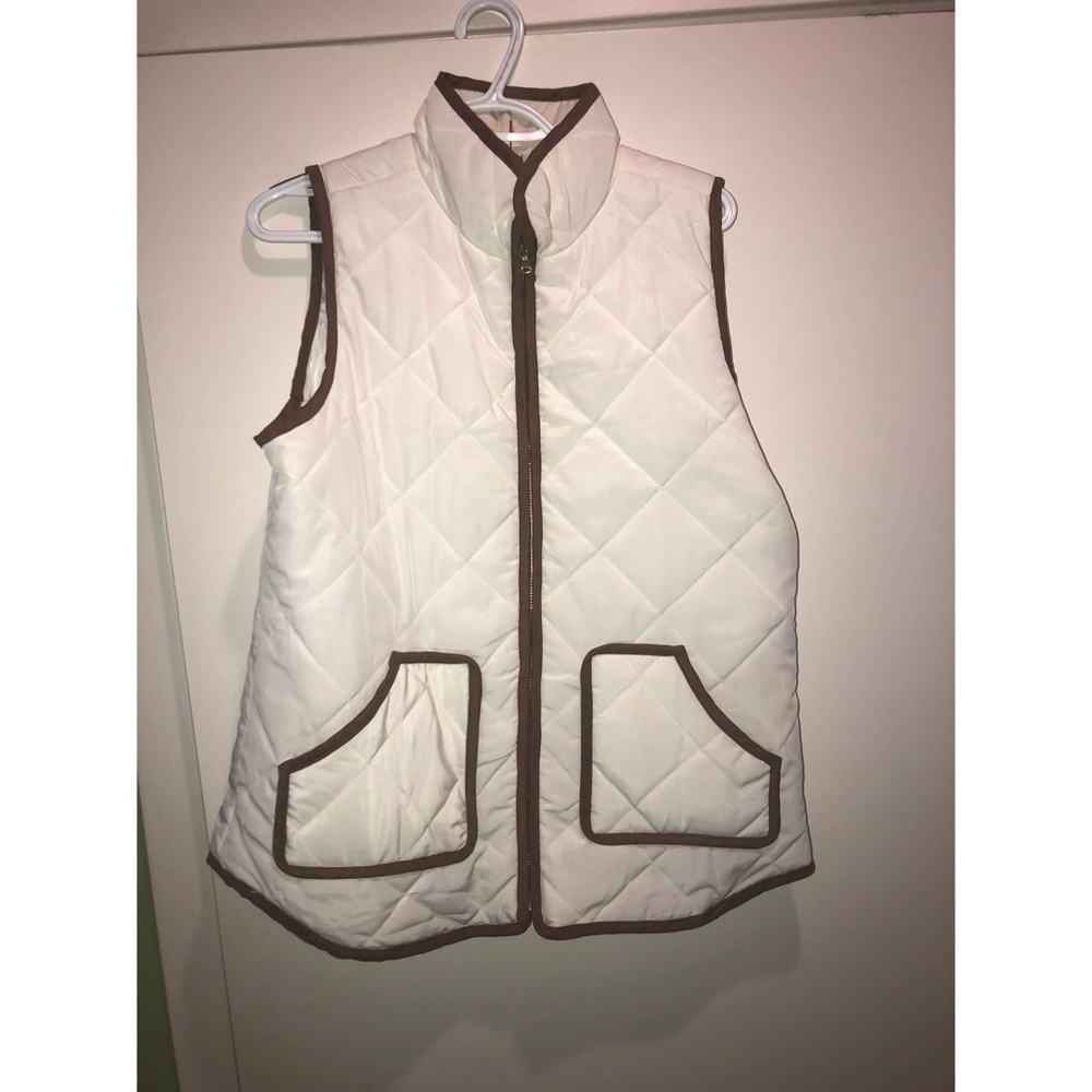 White puffy vest with brown trim.
